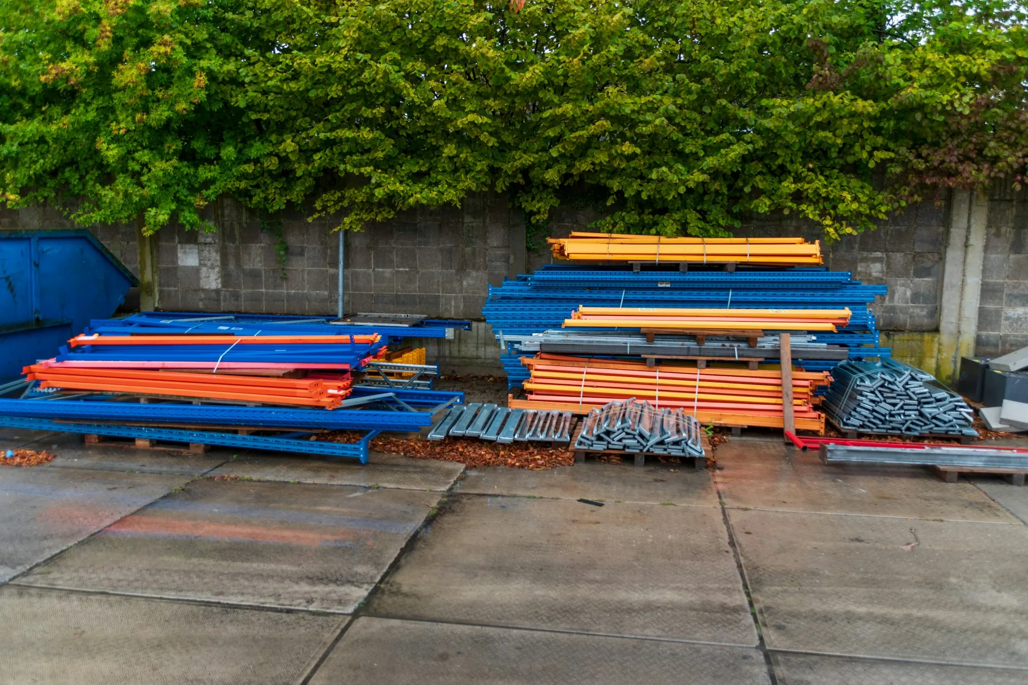 Building materials stacked on pallets in a yard